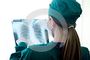 Female women medical doctor looking at x-rays in a hospital .checking chest x ray film at ward