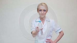 Female woman nutritionist or dietician doctor healthy lifestyle concept - holding bottle of water