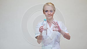 Female woman nutritionist or dietician doctor healthy lifestyle concept - holding bottle of water