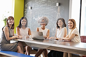 Female work colleagues at informal meeting looking to camera