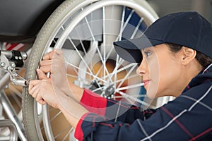 female worker adjusting brakes on wheelchair