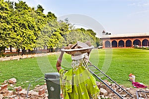 Female worker carries rock waste on her hat