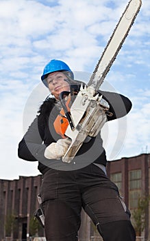Female worker with chainsaw photo