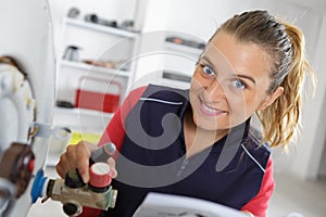 female worker checking boiler