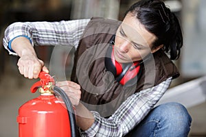 female worker checking pin on fire hydrant