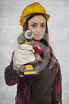 Female worker holding an electric screwdriver