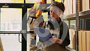 Female worker holding logistics list
