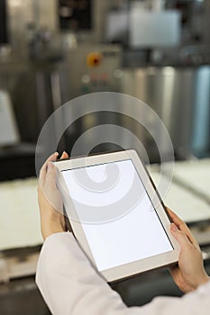 Female Worker Holding Tablet at Food Factory Close Up