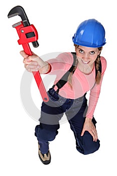 Female worker holding wrench