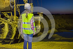 female worker lookis at sandpit on backgroud of photo