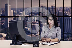 Female worker looks confident in office