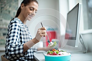 Female Worker In Office Having Healthy Chicken Salad Lunch At Desk