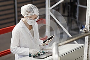 Female Worker Operating Machines at Pharmaceutical Factory