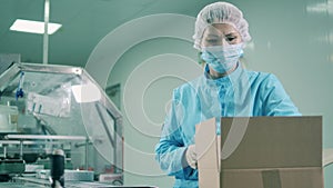 Female worker is packing up pharmacology products