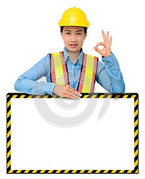 Female worker with Protection Equipment, posing behind big white