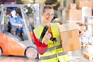 Worker holds package in warehouse of forwarding photo