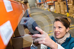 Female worker scanning bar-code packages