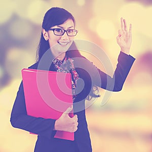 Female worker shows okay sign