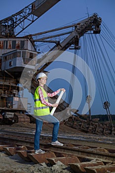 female worker standing on rails on backgroud of photo