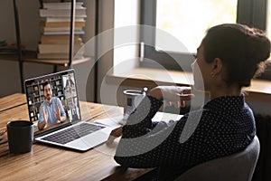 Female worker talk on video call with colleagues