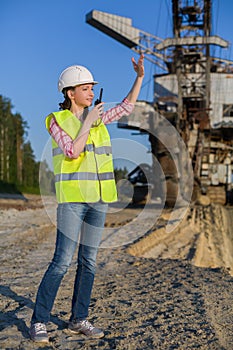 female worker talking on a walkie-talkie on a