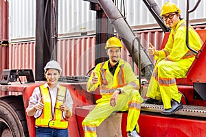 Female worker and two male workers wearing yellow safety vests.