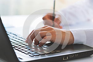 Female worker typing on the keyboard. Distance learning, education online. Online working from home, business and technology