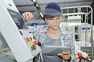 Female worker using digital tablet in manufacturing industry