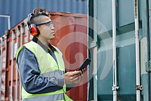 Female worker wearing ear protection at shipping docks