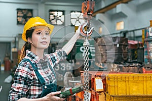 Female worker working on milling machine factory