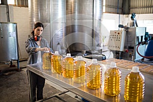 Female worker working in oil factory