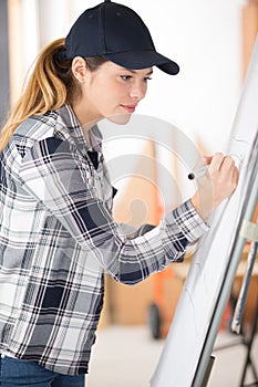 female worker writing on flip chart