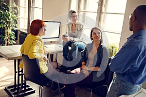 Female workers with manager in office