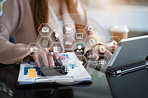 Female businessman working on desk office with using a calculator to calculate the numbers, finance accounting concept.