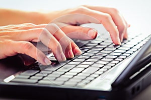 Female working on a laptop.