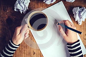 Female writer drinking cup of coffee