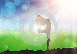 Female in yoga pose against sunny defocussed landscape