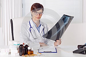 Female young doctor or radiologist with an x-ray