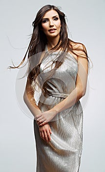 Female young model in silver evening long dress