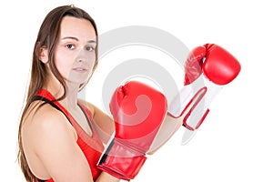 Female young muscular sport boxer with boxing gloves posing over white background