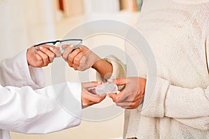 Femalee doctor hands giving glasses and contact lens to patient offering choice, eyesight correction. Ophthalmology