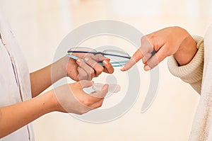 Femalee doctor hands giving glasses and contact lens to patient offering choice, patient choose contact lens, eyesight