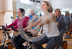 Females on exercise bikes in the gym