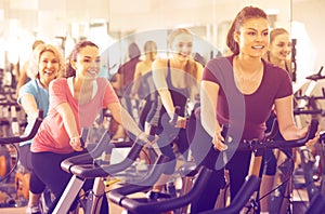 Females riding stationary bicycles