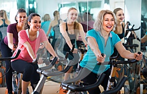 Females riding stationary bicycles