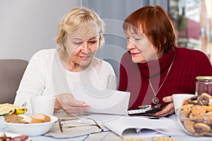 females at the table with utilities bills