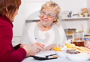 females at the table with utilities bills