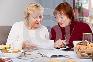 females at the table with utilities bills