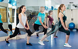Females working out at aerobic class in modern gym
