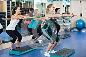 Females working out on aerobic step platform